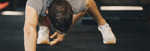 man doing push ups at the gym